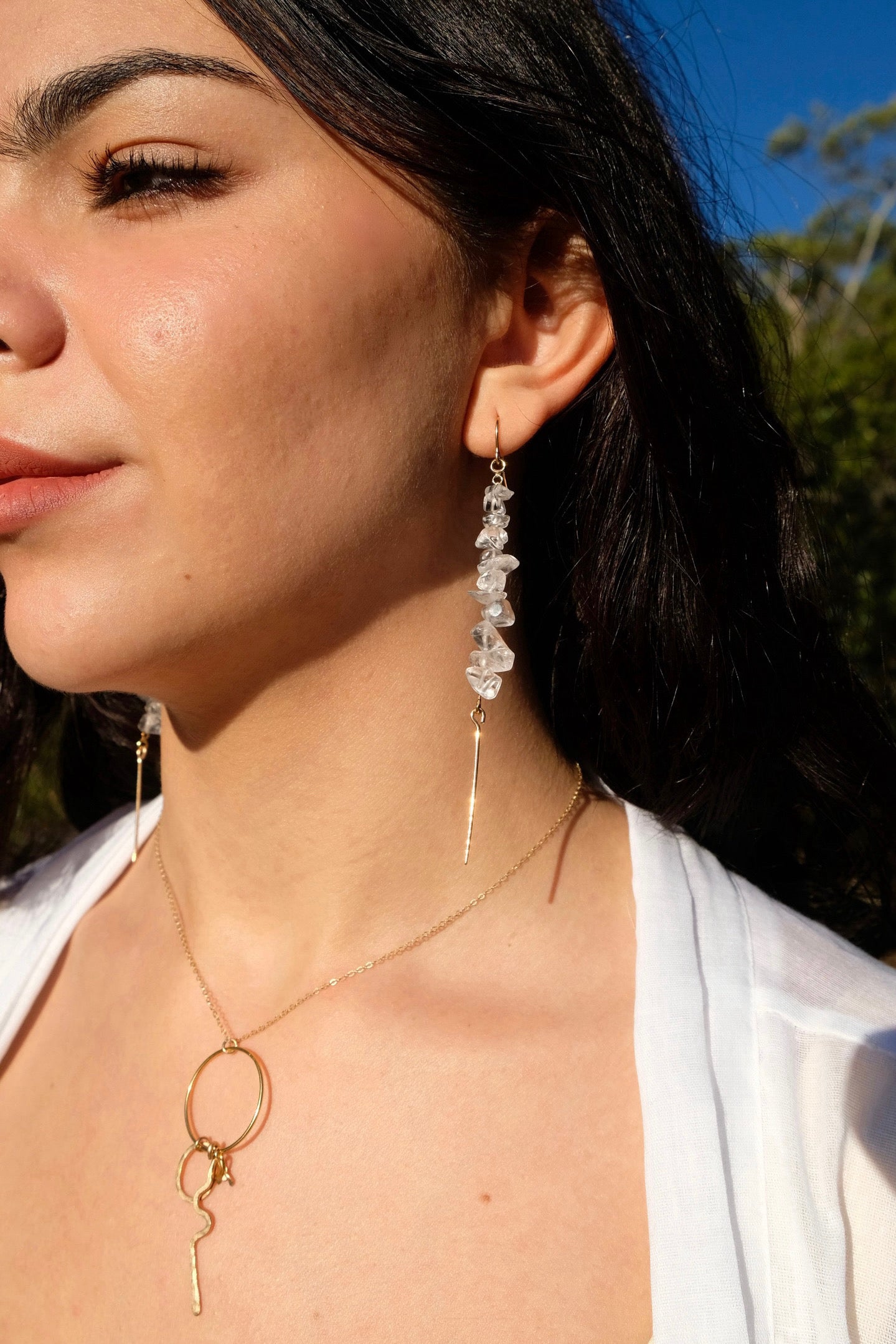 Akari drop earrings, quartz earrings, earrings in gold on model looking forward paired with kirana necklace