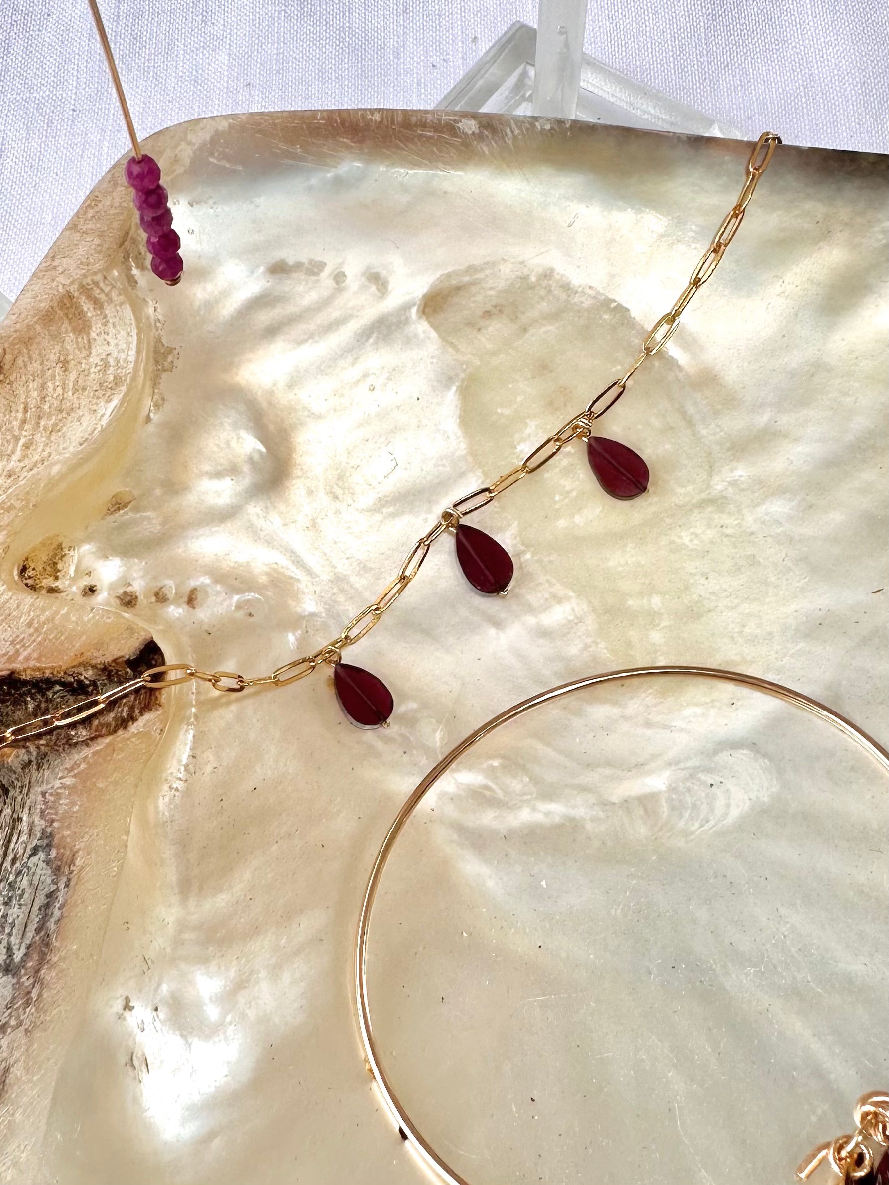 Sajan garnet bracelet, gemstone charm bracelet, gold paperclip bracelet on shell