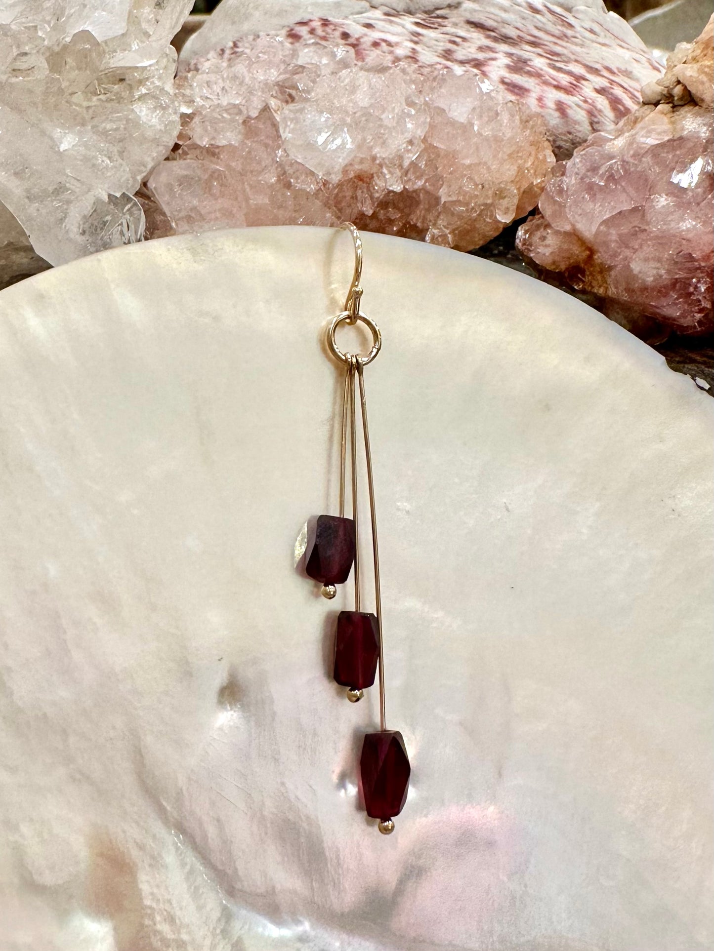 Anahita drop earrings, garnet drop earrings, gold garnet earrings on shell