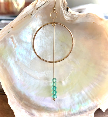 Evyette drop earrings, green gemstone earrings, green onyx earrings in gold close-up on shell