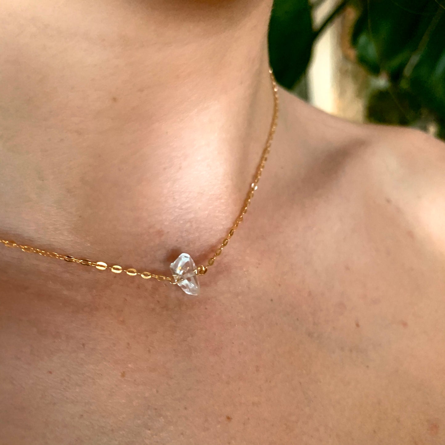 Gracie clear quartz necklace, short gold necklace, crystal quartz necklace in 14k gold fill on model close-up