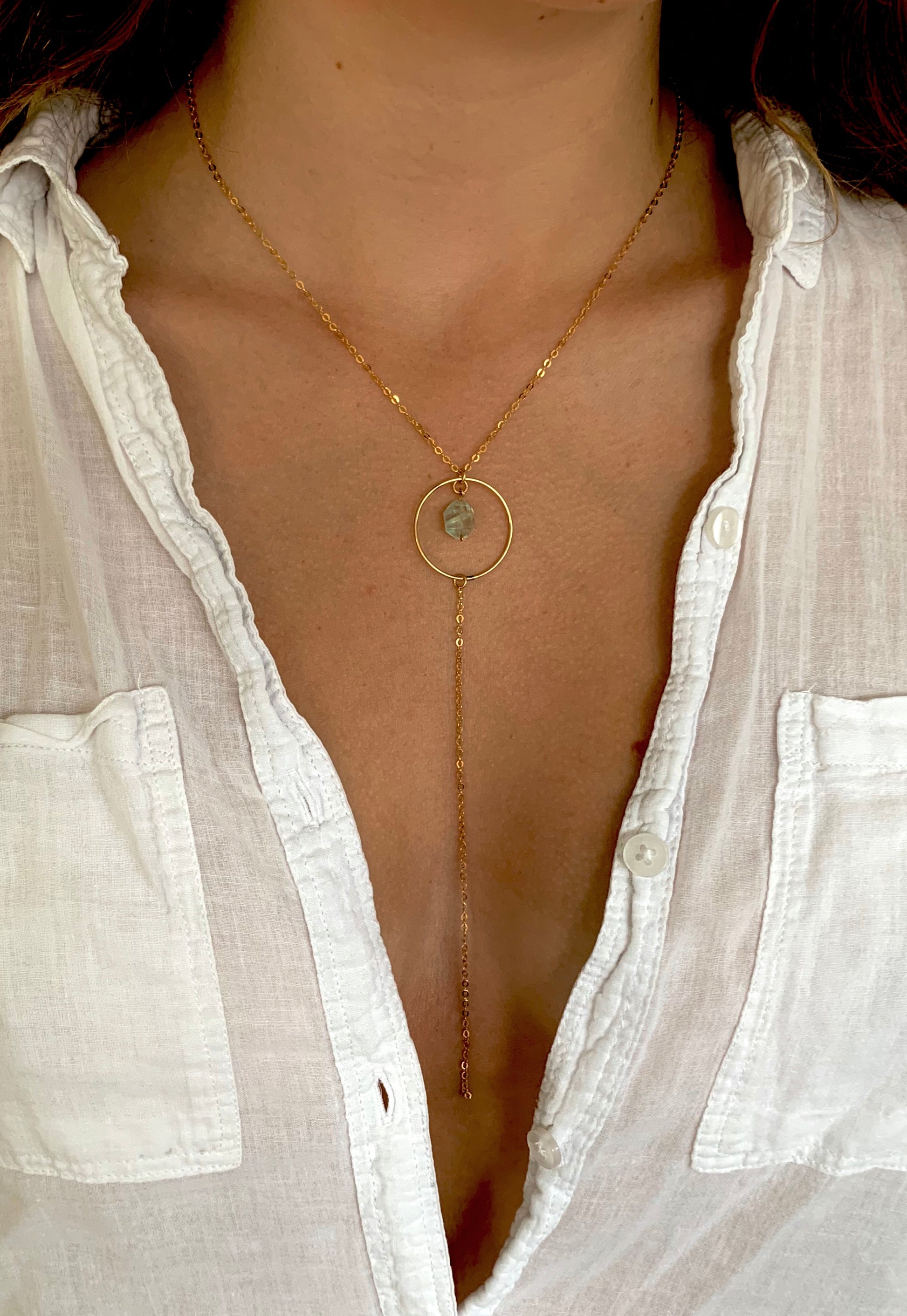 Eden necklace, aquamarine and gold necklace, blue aquamarine necklace in gold on model wearing white button up